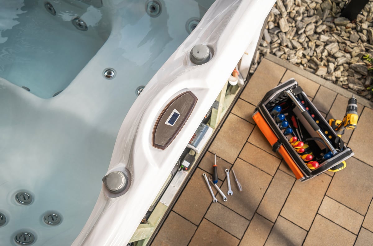 Professional service tools scattered on a hot tub for repair work